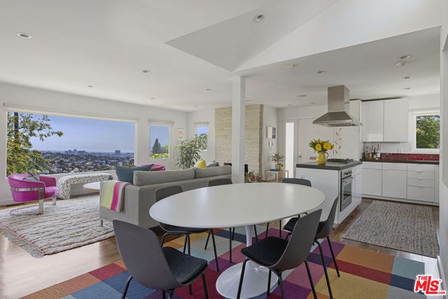a living room with furniture and wall paintings