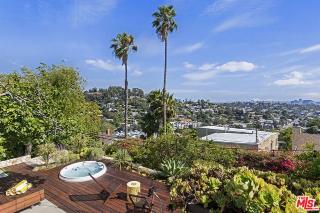 a view of a balcony with chair and potted plants