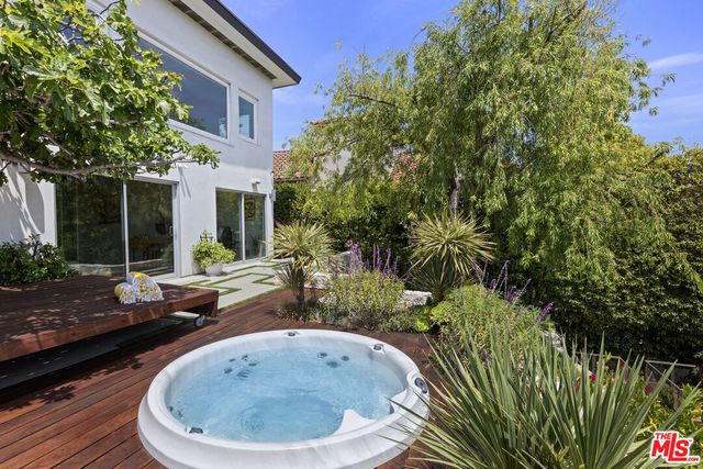 a view of a backyard with table and chairs and potted plants