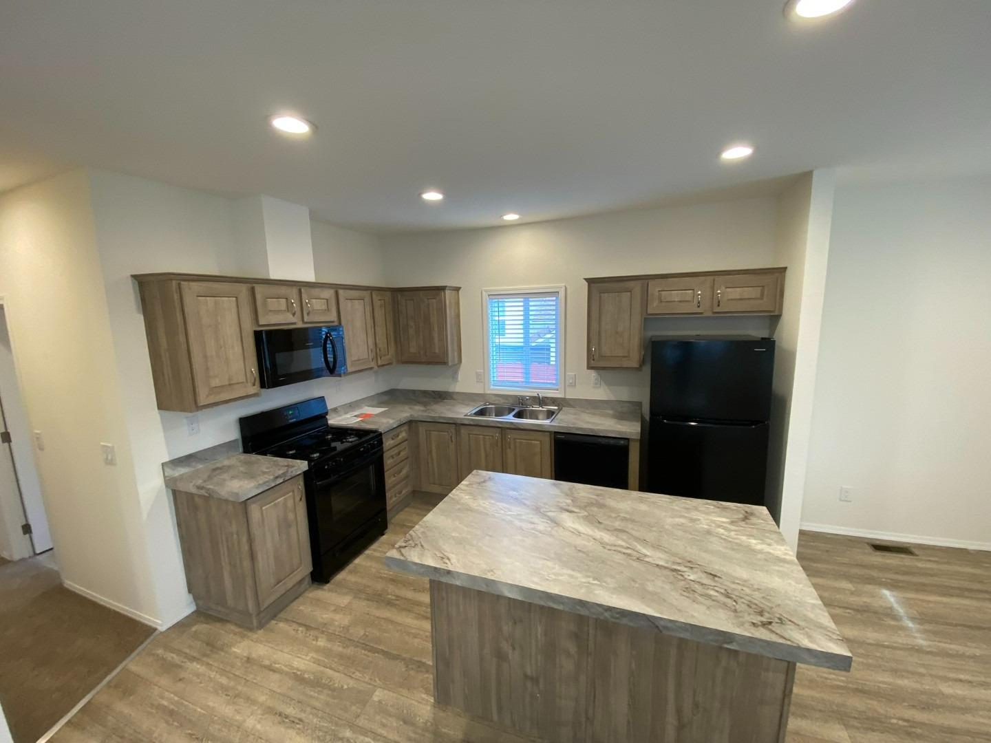 13905 Trinity Mountain Road, Unit 53 French Gulch, CA 96033 - Photo 6 of 10 a kitchen with granite countertop a refrigerator stove and oven