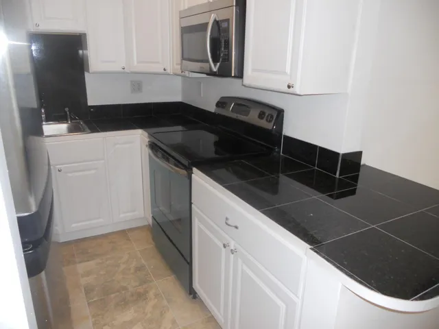 a kitchen with appliances and cabinets