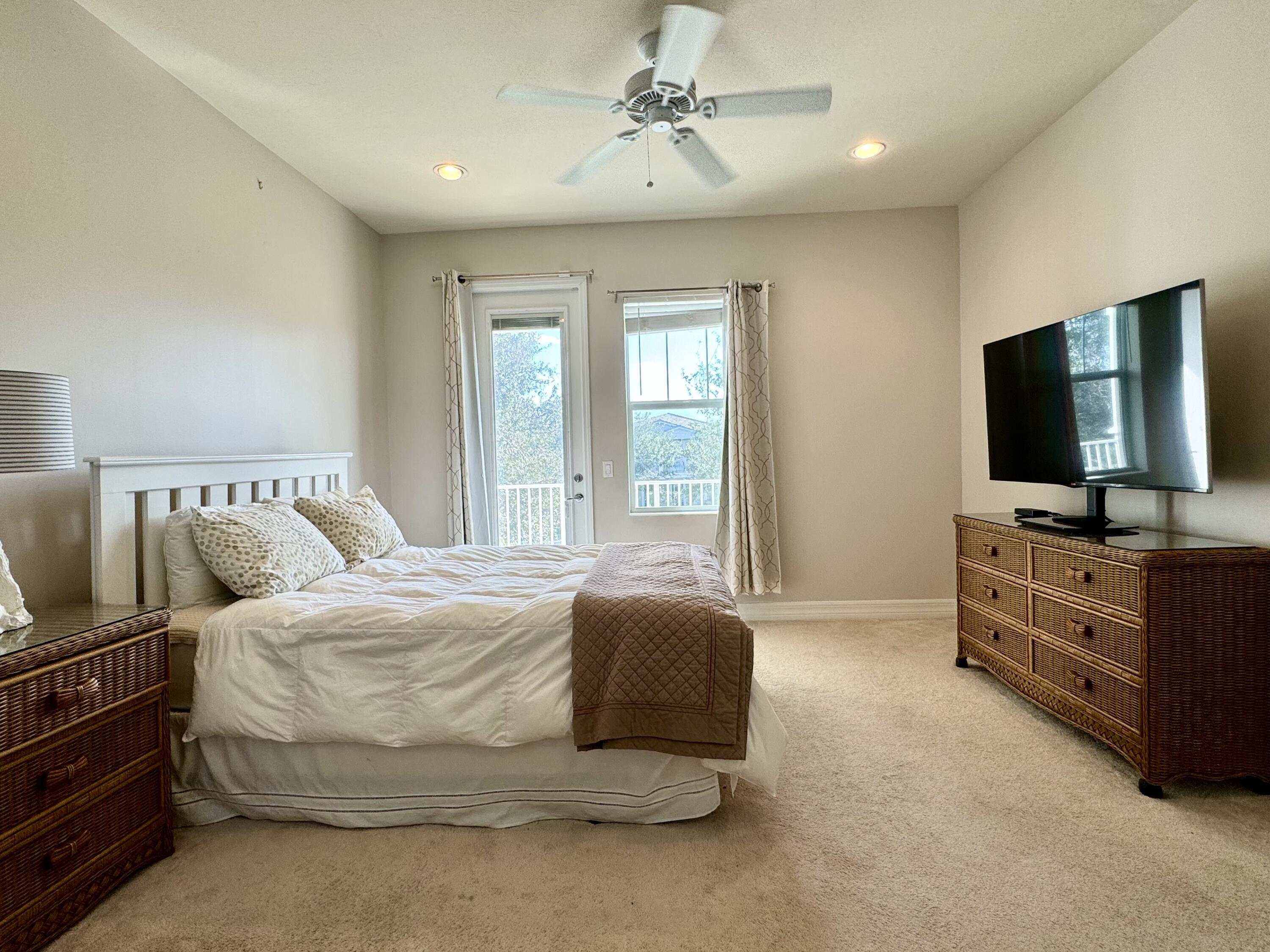 2758 Avalon Way Jupiter, FL 33458 - Photo 20 of 51 a spacious bedroom with a bed and a flat screen tv