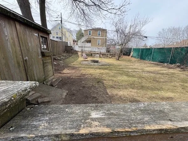 a view of a house with wooden fence