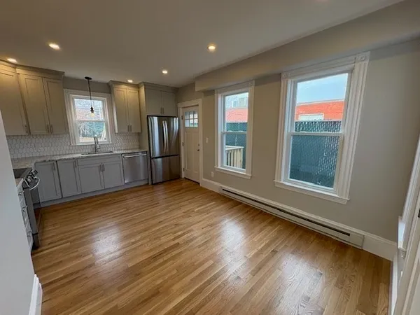a kitchen with stainless steel appliances granite countertop a stove a sink and a refrigerator