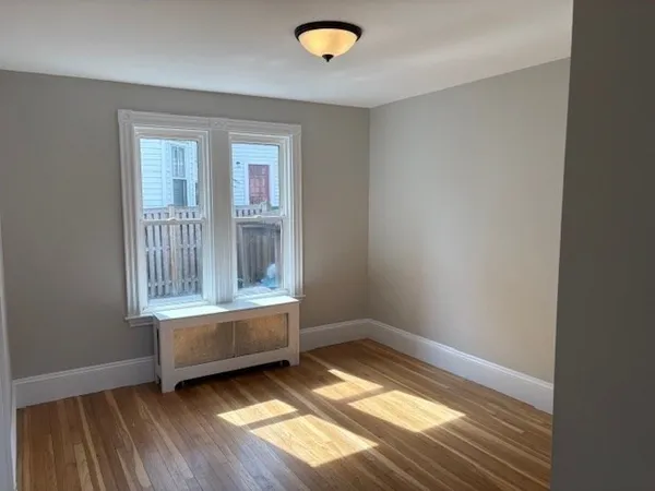 a view of room with window and hardwood floor