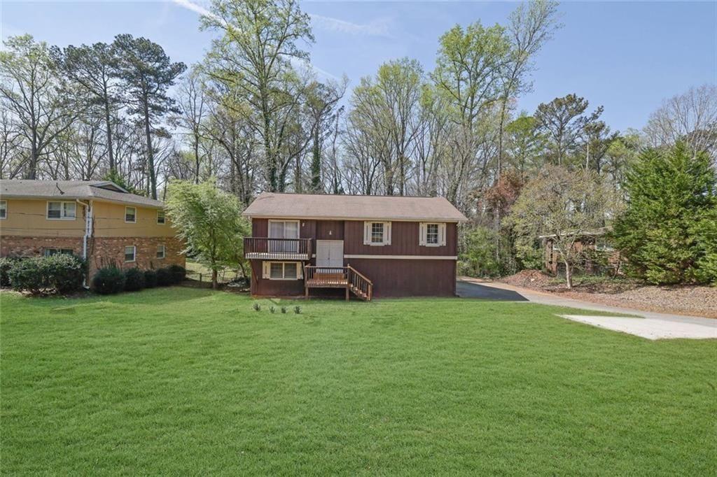 4341 Five Forks Trickum Road Southwest Lilburn, GA 30047 - Photo 31 of 35 a view of a house with a yard