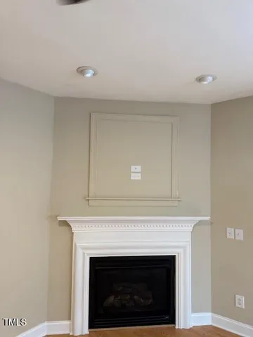 a living room with furniture a flat screen tv and a large window