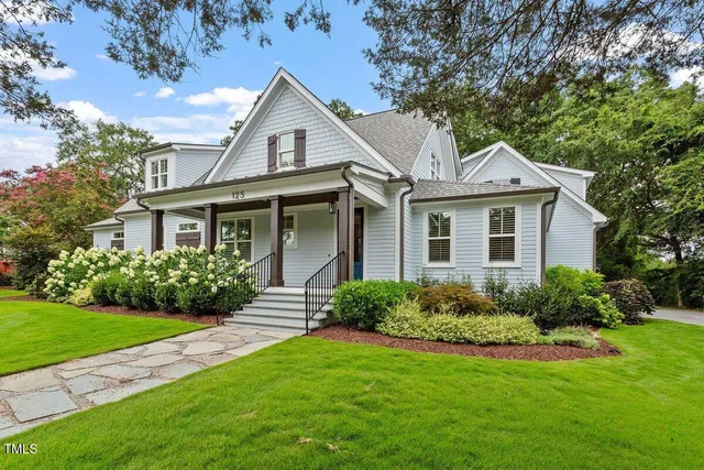 a kitchen with stainless steel appliances kitchen island granite countertop a refrigerator a stove and a sink