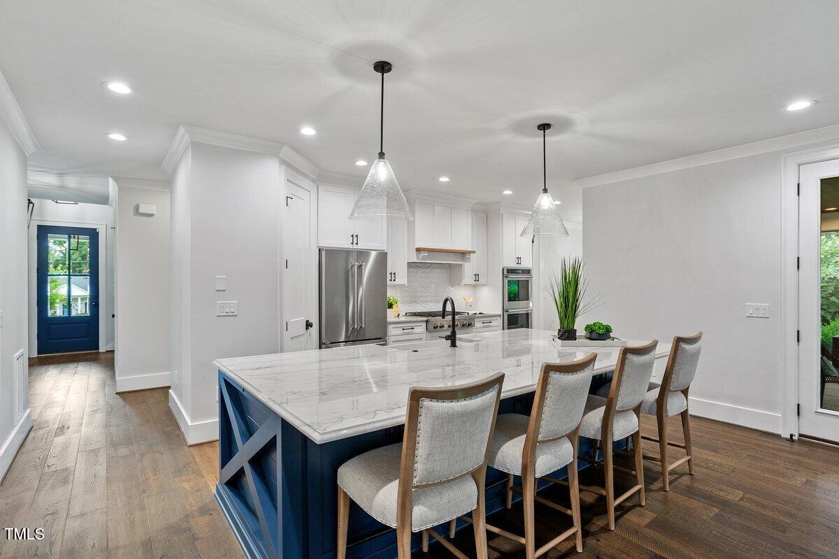 125 Lord Ashley Road Raleigh, NC 27610 - Photo 22 of 85 a view of a dining room and livingroom with furniture wooden floor a chandelier