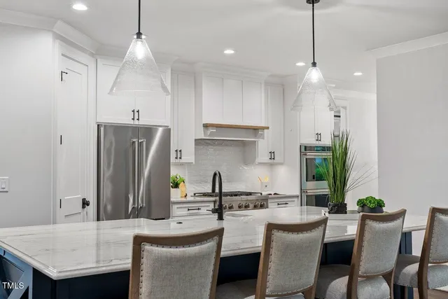 a view of a house with a yard and a large tree