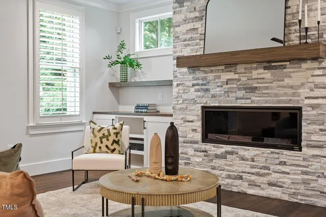 a view of a patio with table and chairs and potted plants with wooden fence