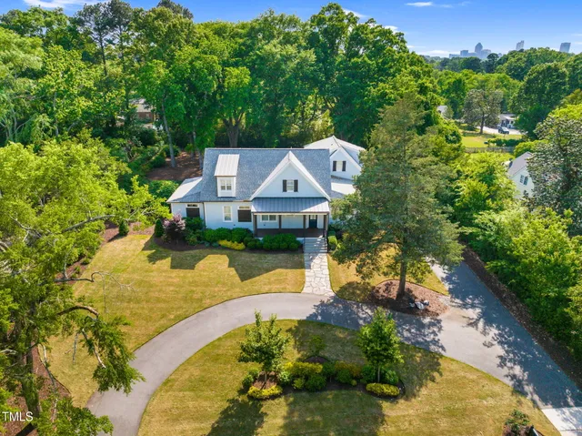 a front view of a house with yard and green space