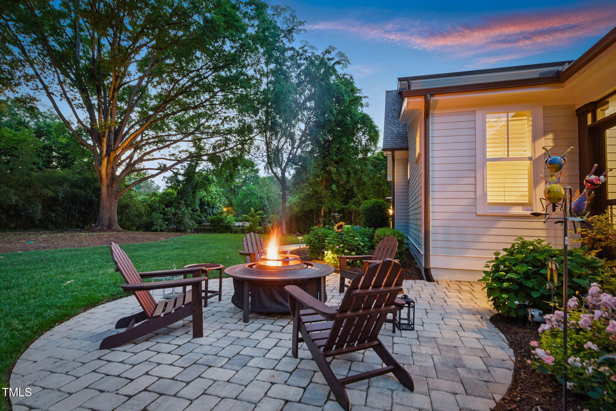 125 Lord Ashley Road Raleigh, NC 27610 - Photo 83 of 85 a view of a patio with table and chairs and potted plants with wooden fence