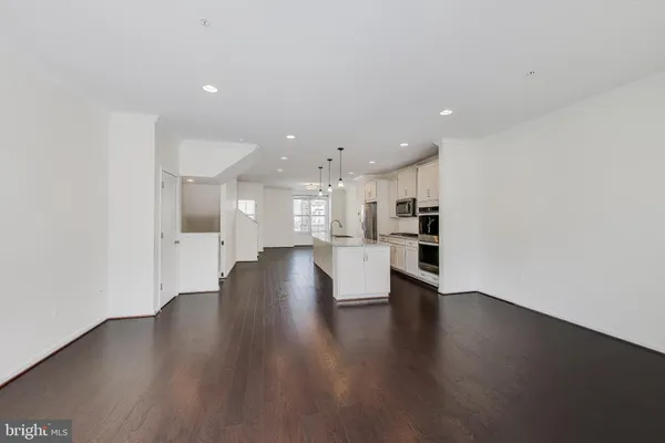 a view of a kitchen with wooden floor and a window