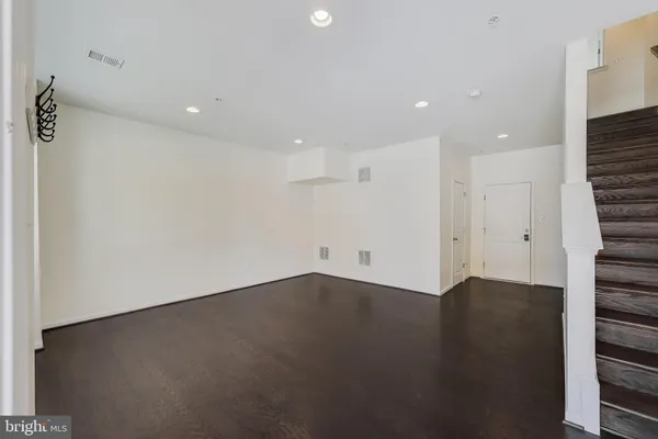 an empty room with wooden floor