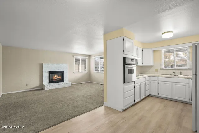 a kitchen with white cabinets and white appliances