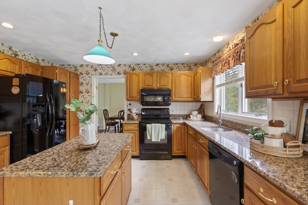 43 Hampshire Road Peabody, MA 01960 - Photo 17 of 42 a kitchen with stainless steel appliances granite countertop a sink a stove and a refrigerator