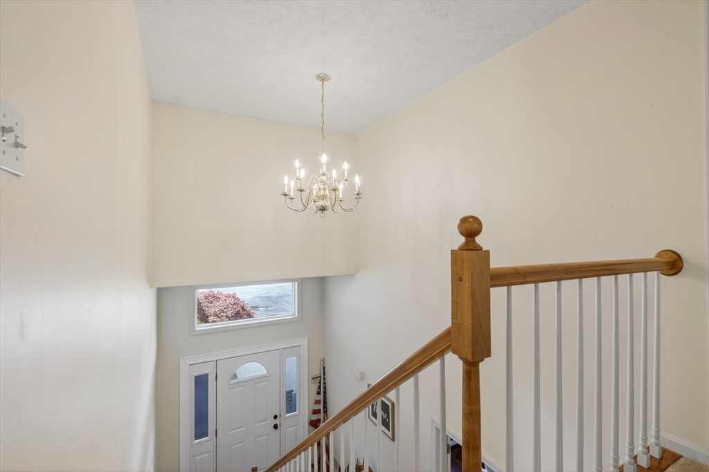 43 Hampshire Road Peabody, MA 01960 - Photo 24 of 42 a view of a hallway with a chandelier