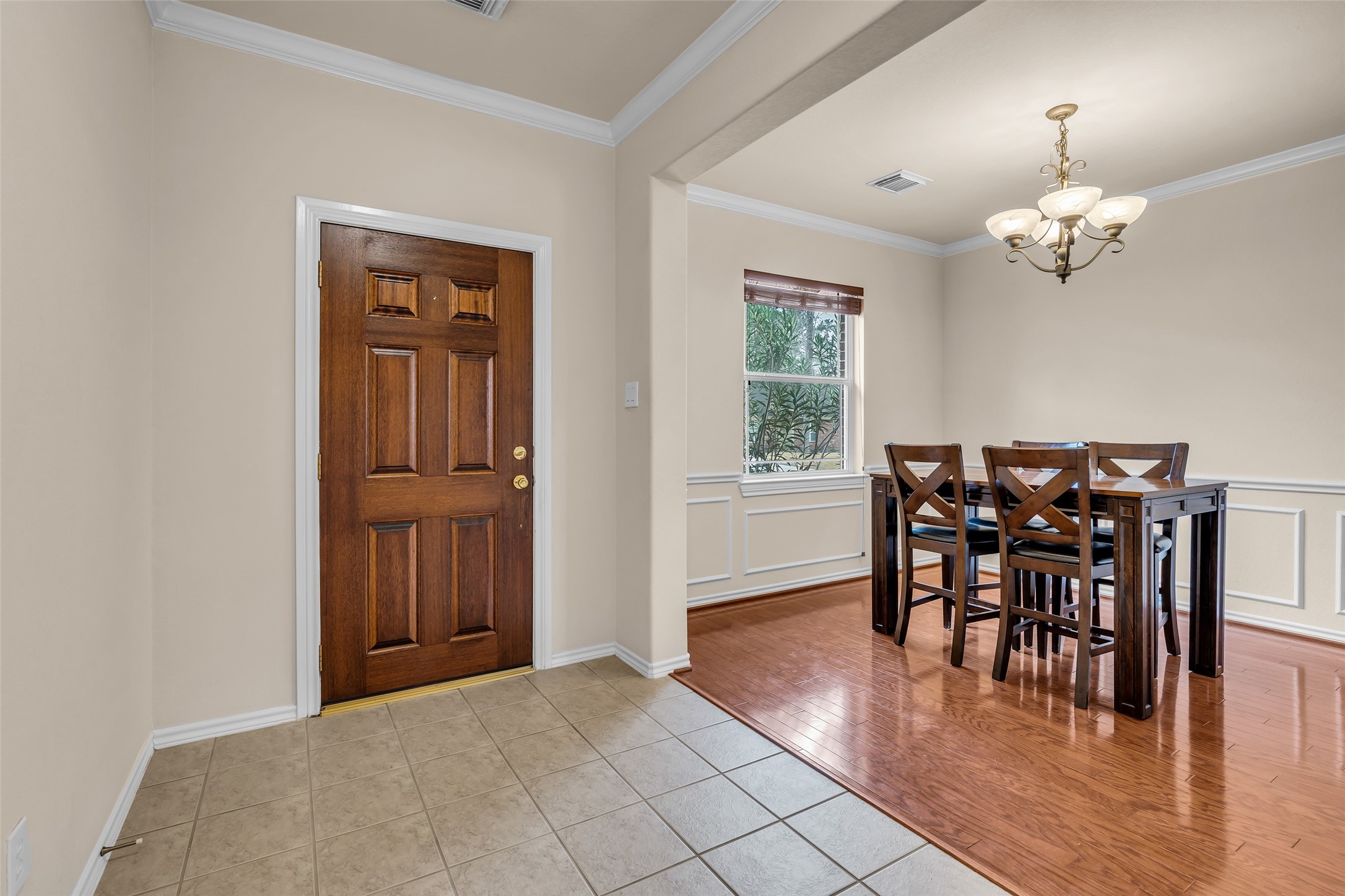 629 Spring Forest Drive Conroe, TX 77302 - Photo 18 of 38 a view of a dining room with furniture window and wooden floor