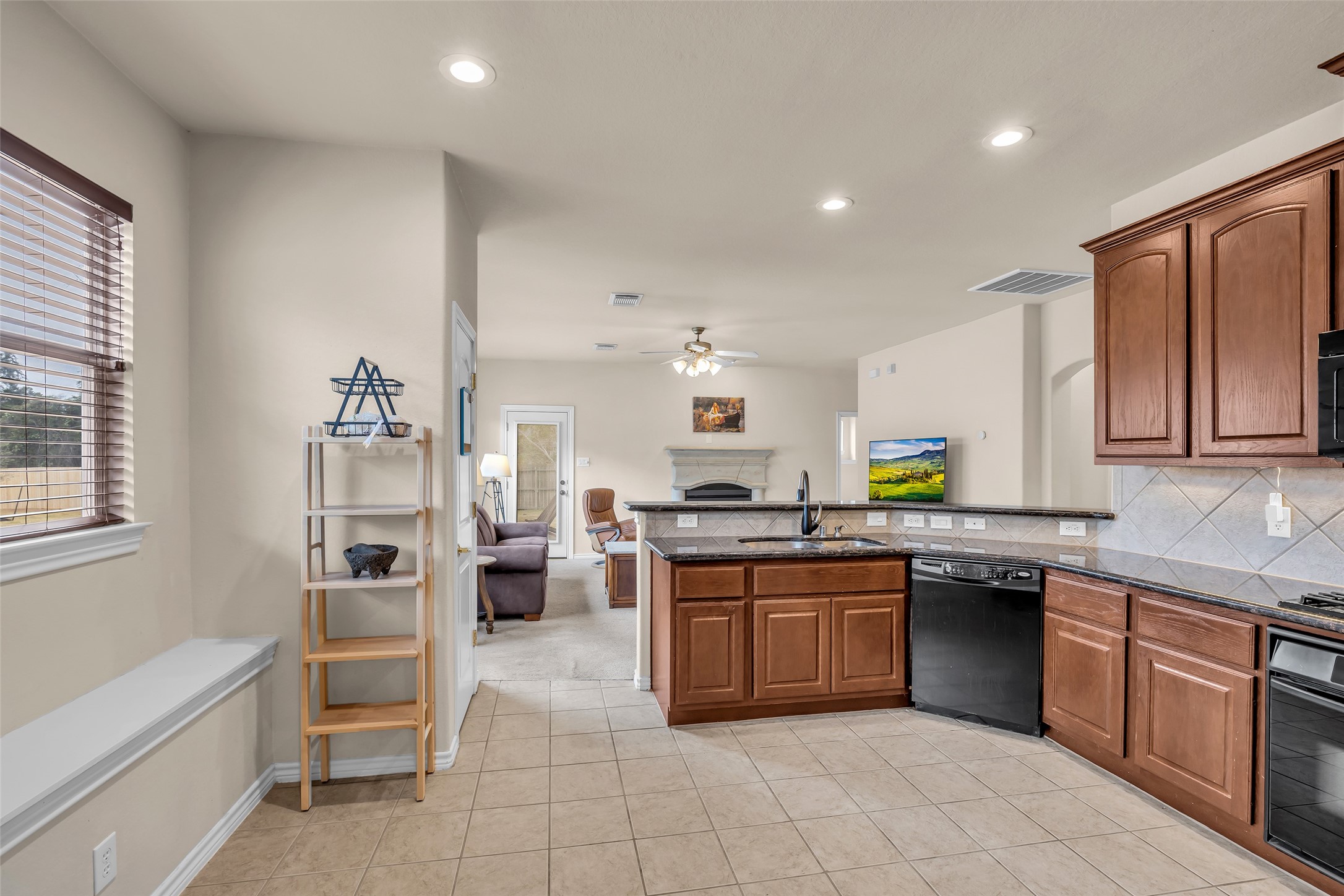 629 Spring Forest Drive Conroe, TX 77302 - Photo 20 of 38 a kitchen with stainless steel appliances granite countertop a stove sink and cabinets