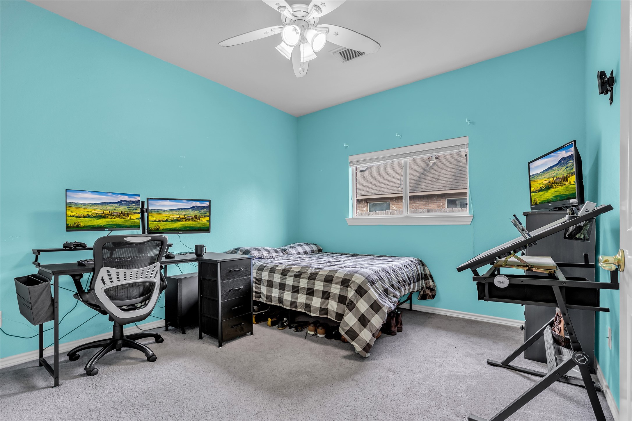 629 Spring Forest Drive Conroe, TX 77302 - Photo 24 of 38 a bedroom with a bed and a chandelier