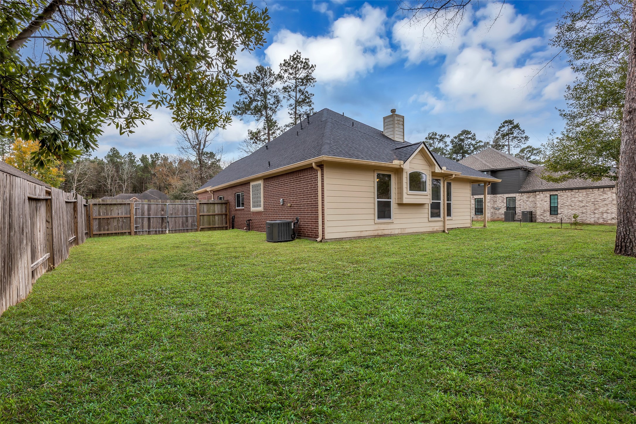 629 Spring Forest Drive Conroe, TX 77302 - Photo 30 of 38 a view of a yard in front of a house with a large tree
