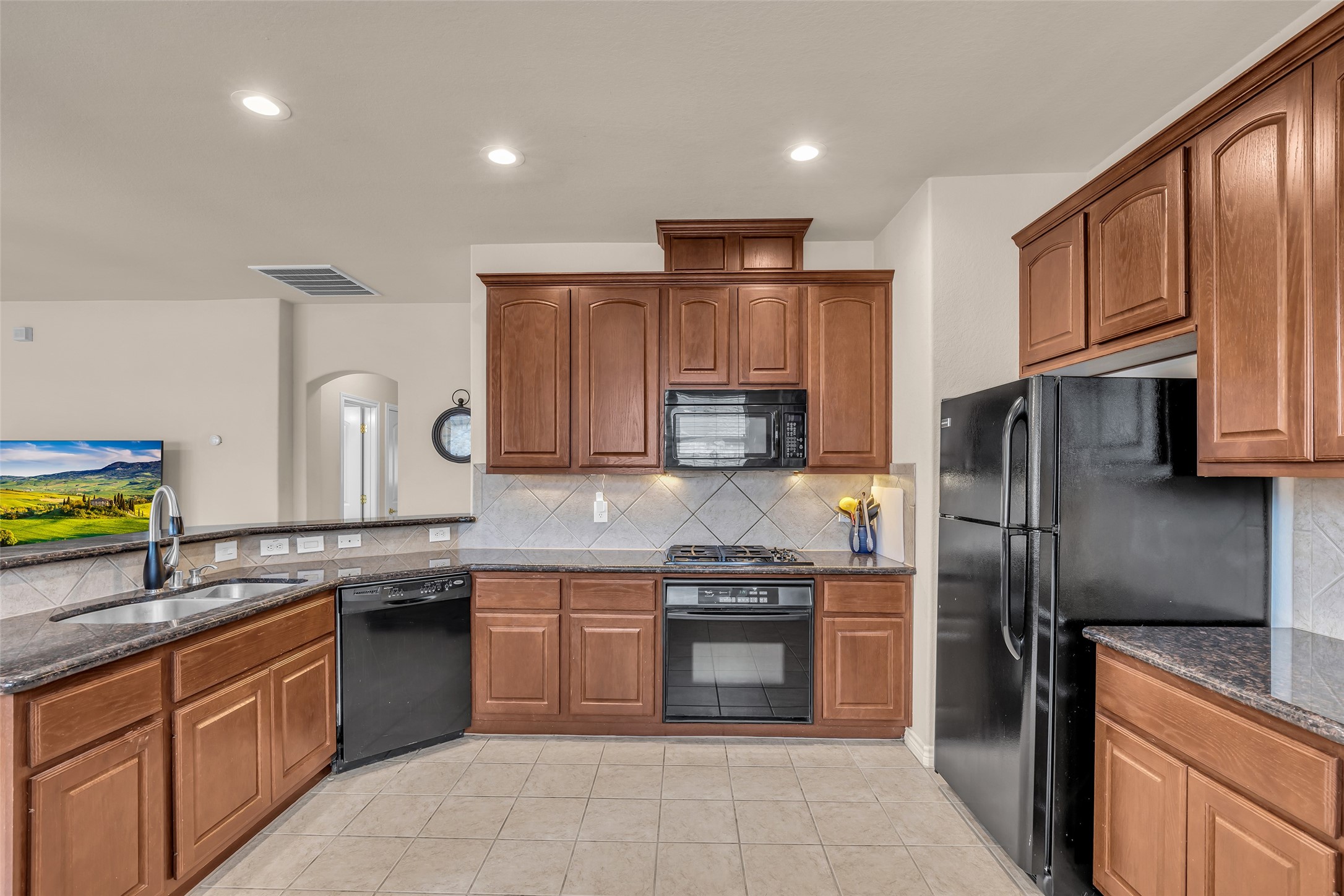 629 Spring Forest Drive Conroe, TX 77302 - Photo 3 of 38 a kitchen with stainless steel appliances granite countertop a refrigerator stove and sink