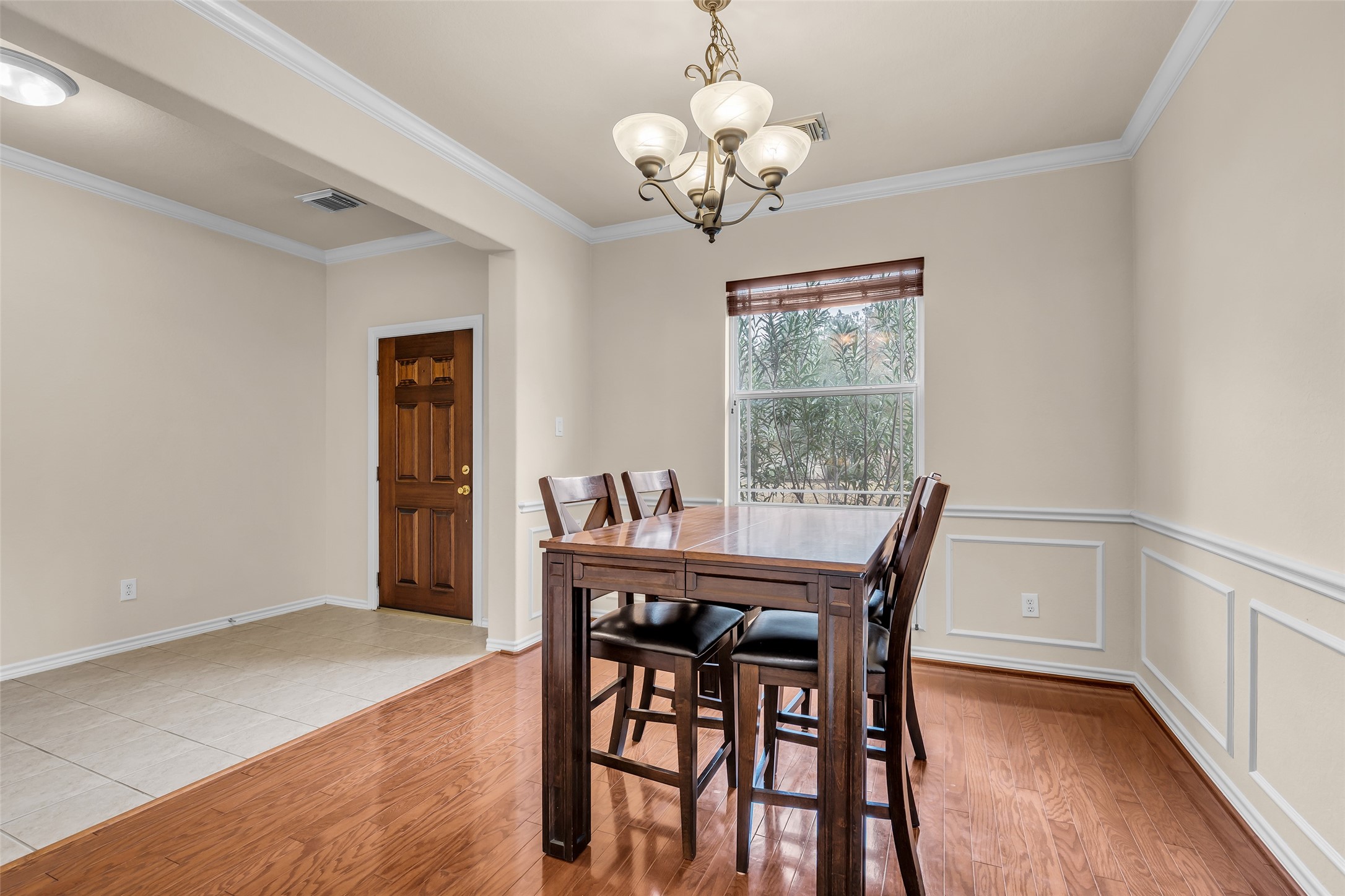 629 Spring Forest Drive Conroe, TX 77302 - Photo 4 of 38 a view of a dining room with furniture window and wooden floor