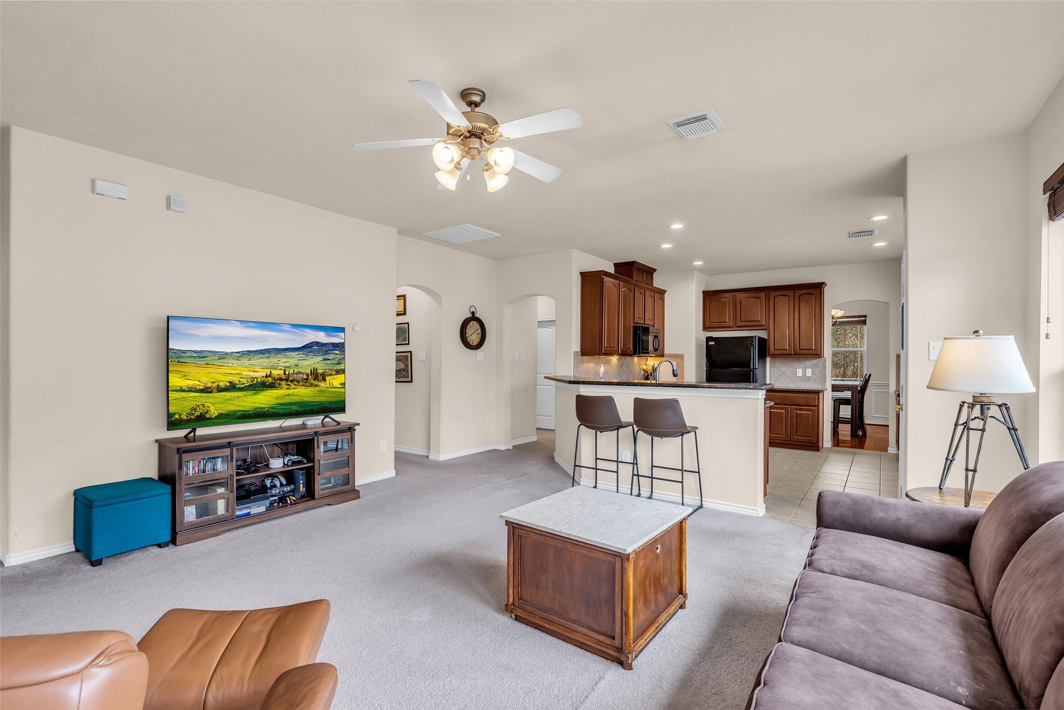 629 Spring Forest Drive Conroe, TX 77302 - Photo 5 of 38 a living room with furniture and a flat screen tv