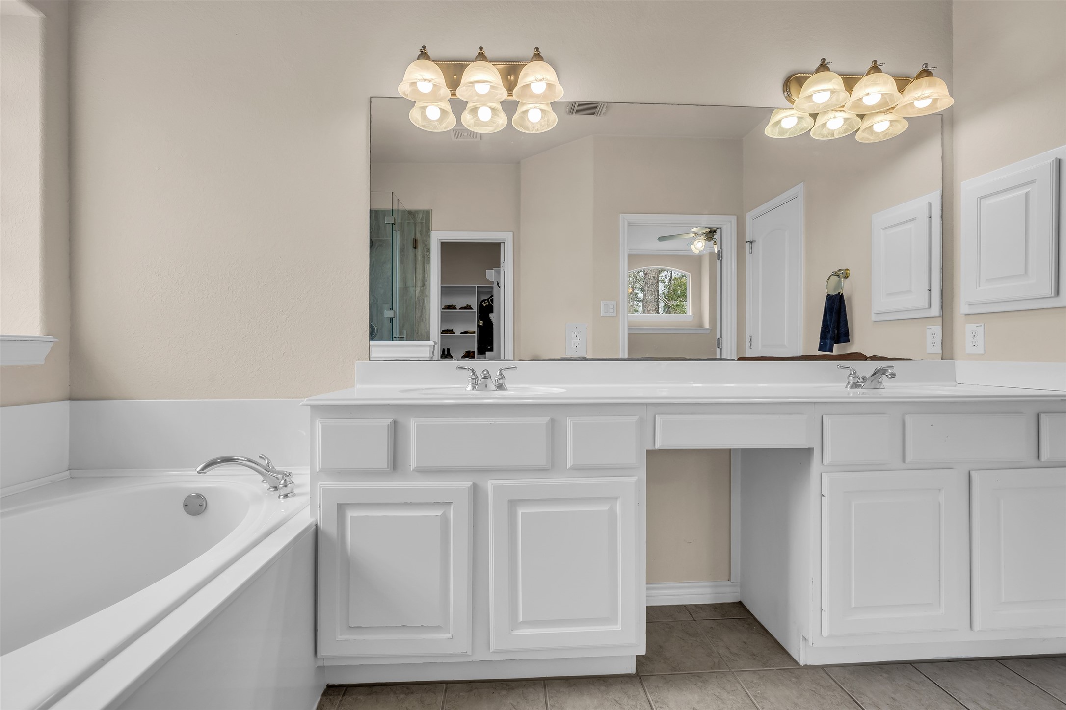 629 Spring Forest Drive Conroe, TX 77302 - Photo 10 of 38 a bathroom with a sink and a large mirror