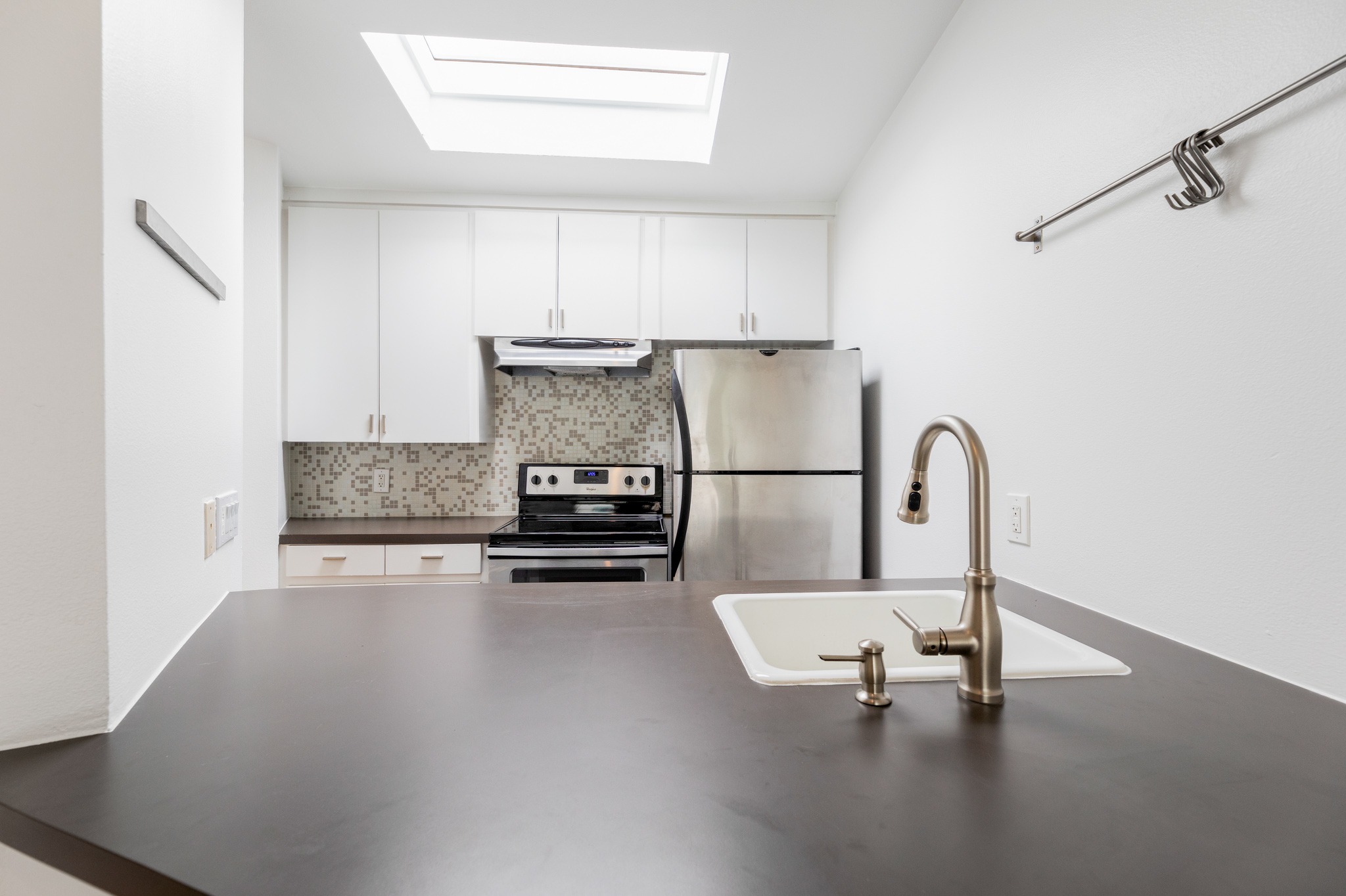2308 Enfield Road, Unit 204 Austin, TX 78703 - Photo 14 of 30 a kitchen with a refrigerator and white cabinets