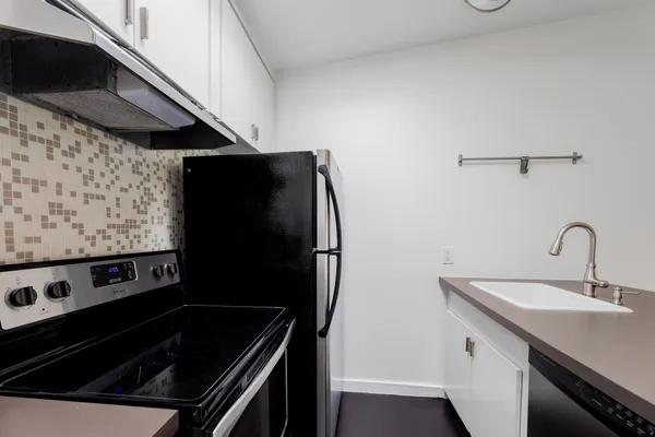 a kitchen with a stove and a refrigerator
