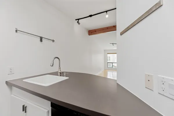 a close view of a sink a faucet and a table in a room