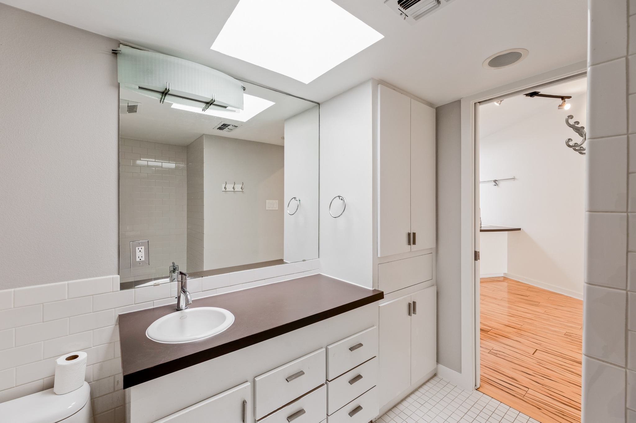 2308 Enfield Road, Unit 204 Austin, TX 78703 - Photo 23 of 30 a bathroom with a granite countertop sink and a mirror