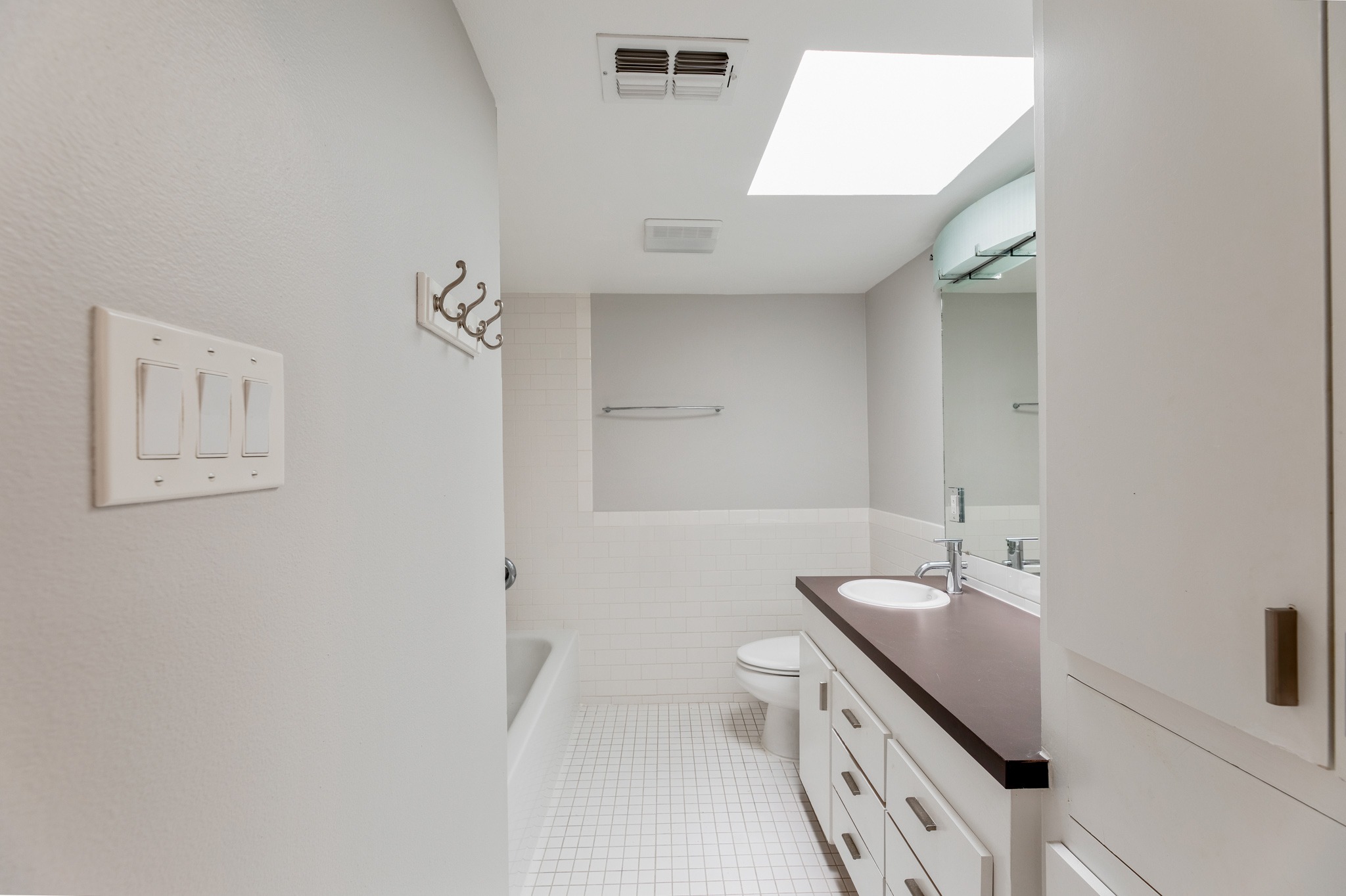 2308 Enfield Road, Unit 204 Austin, TX 78703 - Photo 26 of 30 a bathroom with a granite countertop sink and a mirror