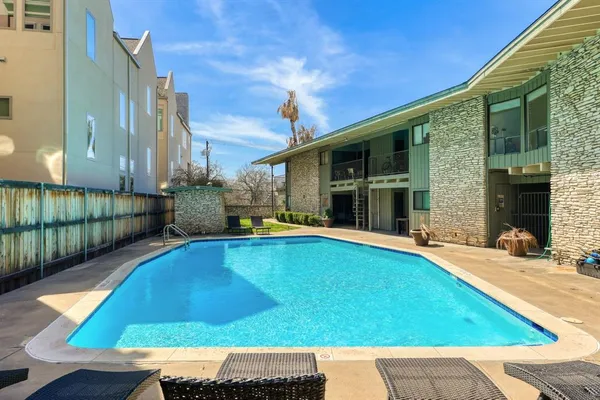 a view of a backyard with swimming pool