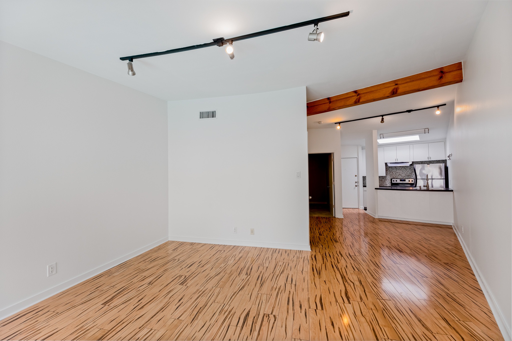 2308 Enfield Road, Unit 204 Austin, TX 78703 - Photo 6 of 30 a view of a big room with wooden floor and a kitchen