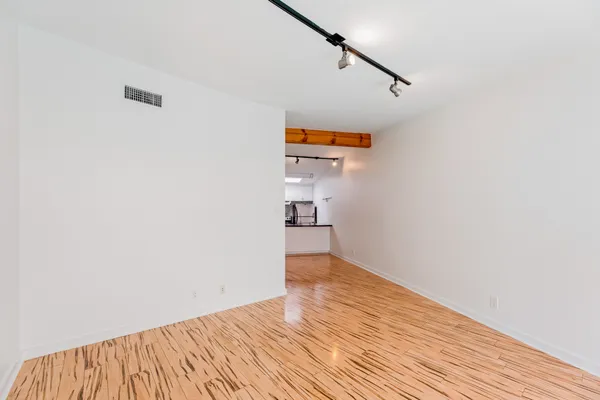 a view of a room with wooden floor and staircase