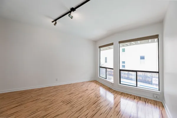 wooden floor in an empty room with a window