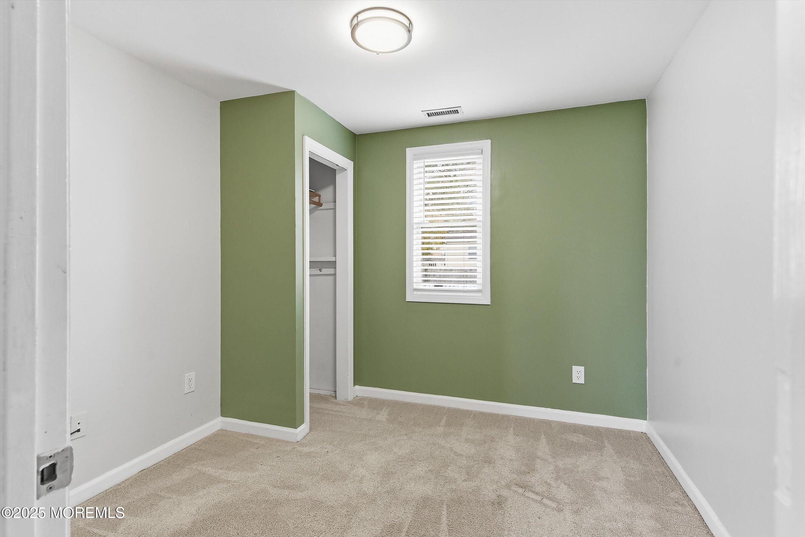 625 Drum Point Road Brick, NJ 08723 - Photo 12 of 22 a view of an empty room with closet and a window