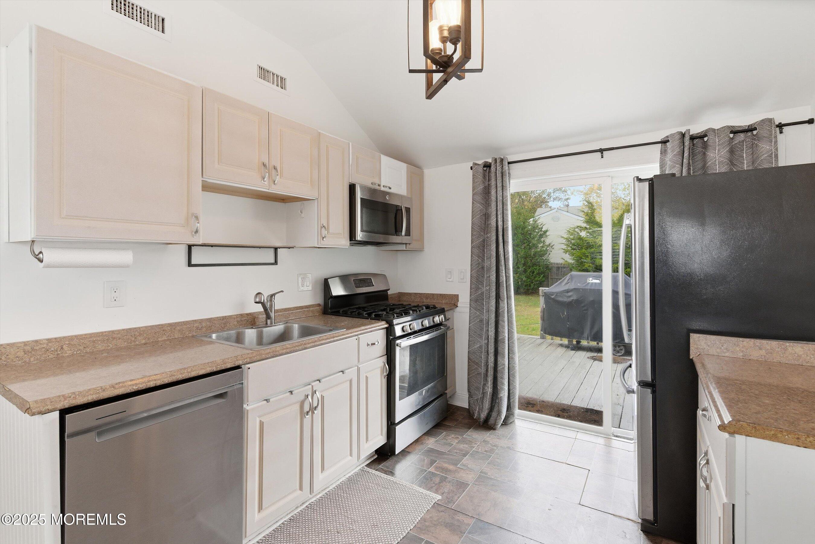625 Drum Point Road Brick, NJ 08723 - Photo 8 of 22 a kitchen with stainless steel appliances granite countertop a sink stove and refrigerator
