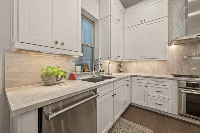 a kitchen with granite countertop cabinets and white appliances