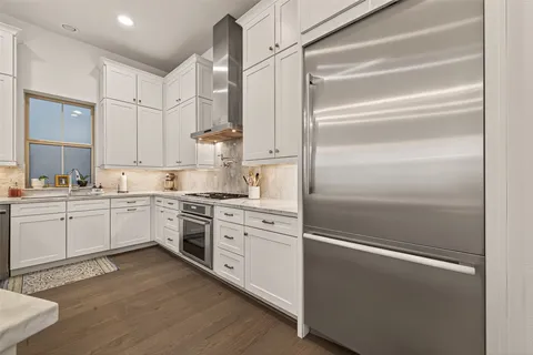 a kitchen with cabinets stainless steel appliances and a counter space