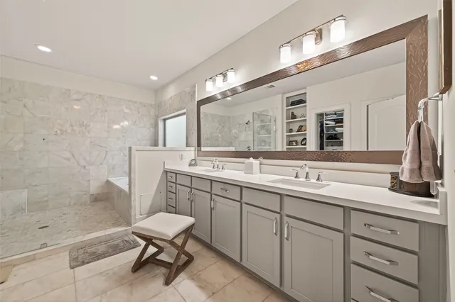a spacious bathroom with a shower sink mirror and toilet