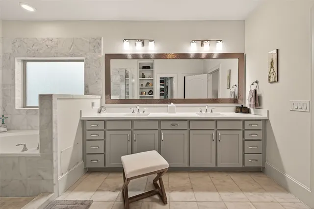 a spacious bathroom with a granite countertop sink and a mirror