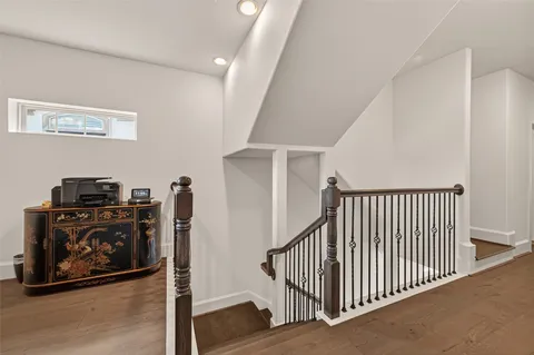 a view of a hallway with workspace wooden floor and windows