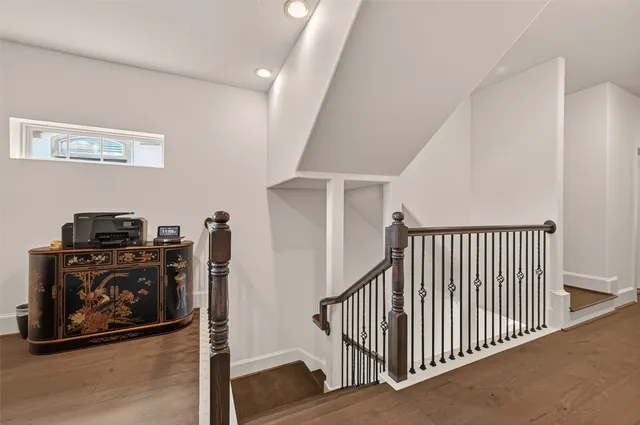 a view of a hallway with workspace wooden floor and windows