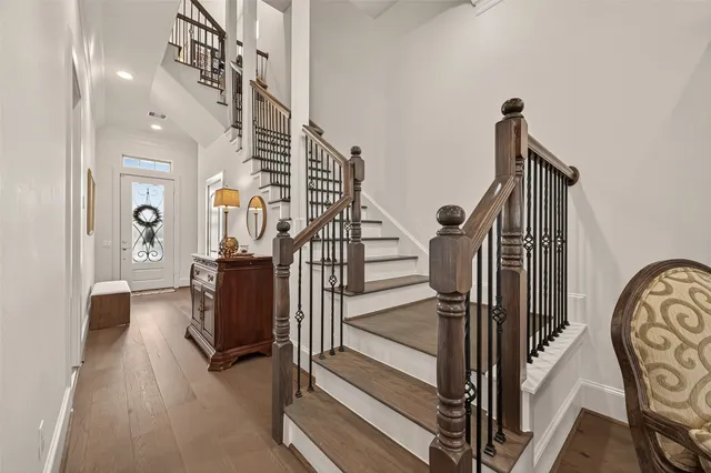 a view of entryway and hall with wooden floor