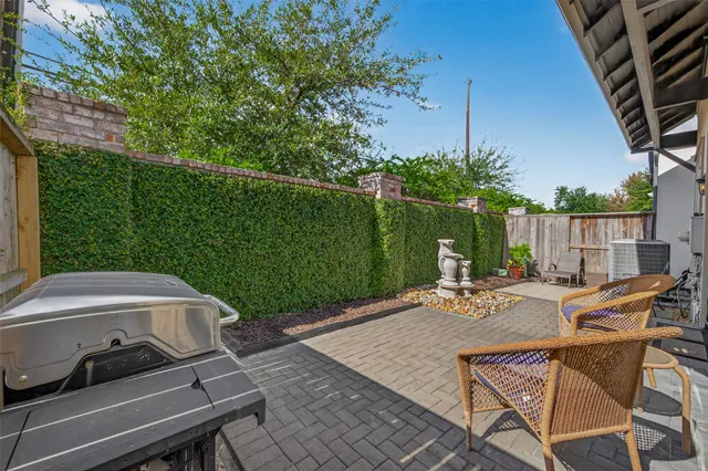 a view of a backyard with sitting area