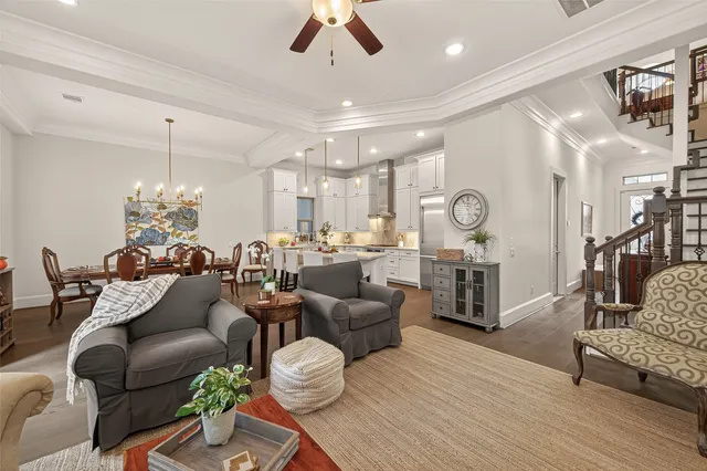 a living room with furniture and a chandelier